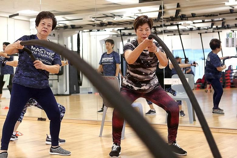 Madam Doris Mok (left), 70, and Ms Alice Tan, 72, taking part in a class at Heartbeat@Bedok ActiveSG Gym yesterday. They are among senior citizens who will benefit from the free access to ActiveSG's 26 pools and 24 gyms.