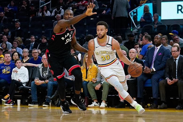 Golden State Warriors guard Stephen Curry (right) driving past Toronto Raptors centre Serge Ibaka on his return to action on Thursday after four months out with a broken hand. But National Basketball Association champions Toronto, led by Norm Powell'