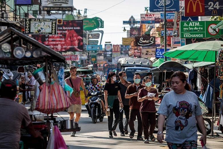 People walking along Bangkok's Khao San Road yesterday. The coronavirus outbreak has severely affected tourism. The Tourism Authority of Thailand says the country could see a loss of six million visitors this year.