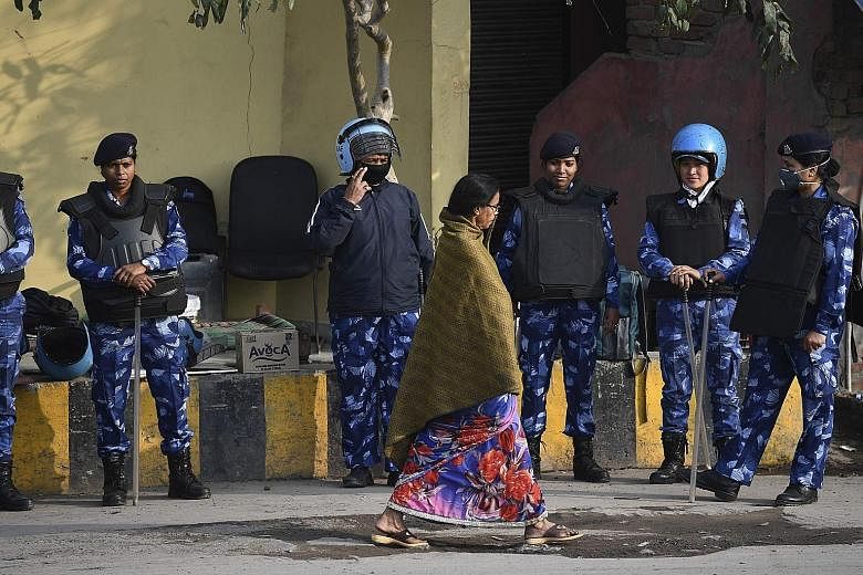 Indian security personnel standing guard in a riot-affected area in New Delhi last Sunday, after communal riots broke out in India's capital late last month, leaving at least 53 people dead. In north-east Delhi, police have been accused of both inact