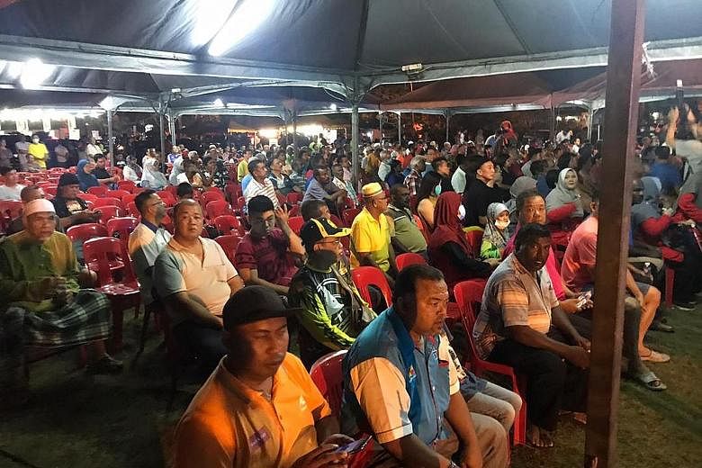 People attending Pakatan Harapan's roadshow in Taman Sri Andalas, Klang, last night. The spirited speeches by PH leaders were peppered with cries of betrayal and corruption, and criticism of the "backdoor government".