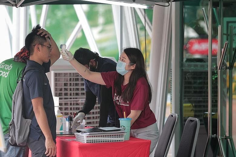 Temperature screening being carried out at Safra Jurong on Friday. An event at Safra Jurong has been linked to 21 Covid-19 cases. It is understood that not all the patients from the cluster had attended the event.