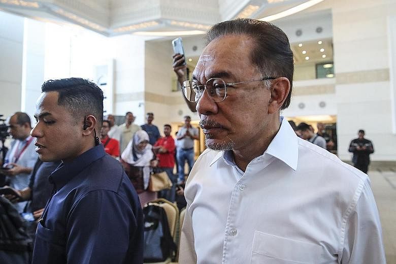 PKR leader Anwar Ibrahim arriving for a press conference in Kuala Lumpur on March 1, after his party lost power. Yesterday, he voiced his concerns over fellow PH lawmakers being wooed to switch their support to Malaysia's new Prime Minister Muhyiddin