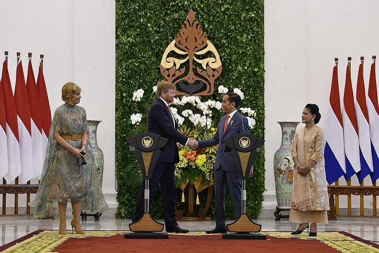 The Netherlands' King Willem-Alexander getting a warm welcome from Indonesia's President Joko Widodo yesterday, as their respective spouses, Queen Maxima and First Lady Iriana, looked on. The Dutch king apologised for the "excessive violence" inflict