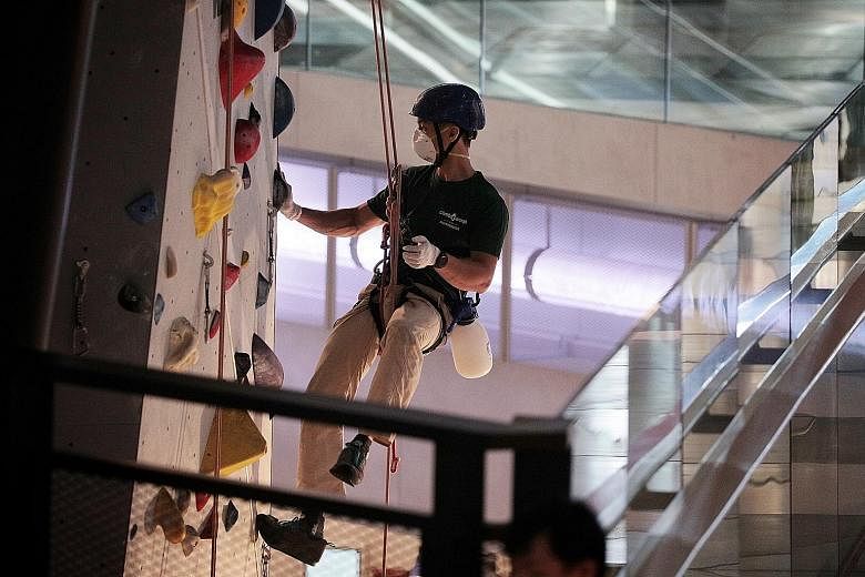 A staff member of Climb Central cleaning the facility at Funan Mall yesterday. The climbing gym, which also has outlets in Kallang Wave Mall and Novena Square, said on social media on Tuesday that a climber who visited its Funan branch on Sunday has 