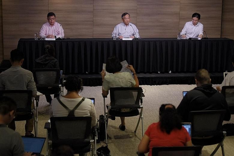 (From right) National Development Minister Lawrence Wong, Health Minister Gan Kim Yong and Ministry of Health director of medical services Kenneth Mak walking the talk on social distancing at yesterday's press conference on the local Covid-19 situati