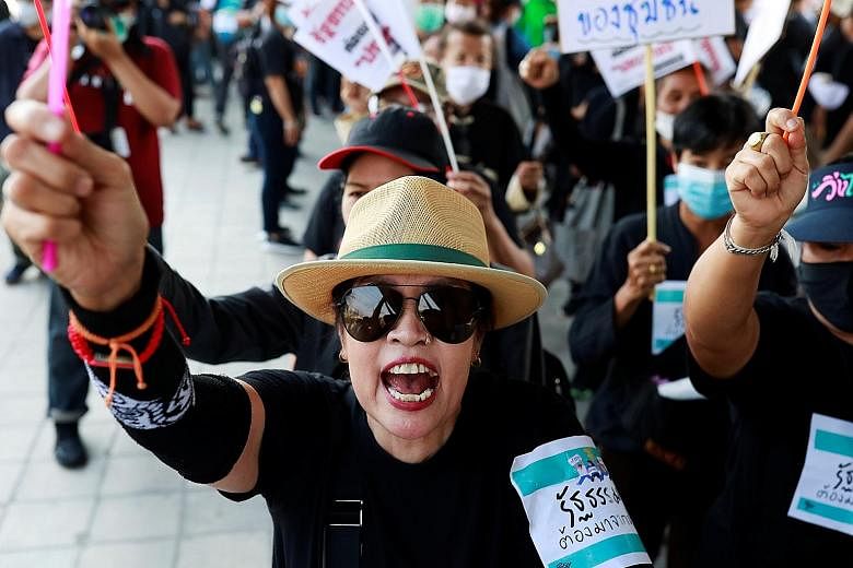 Protesters marching on Parliament in Bangkok yesterday. Discontent with Thailand's administration is seething, with a progressive opposition party, the Future Forward Party, disbanded and the country's economy faltering as the coronavirus crisis batt