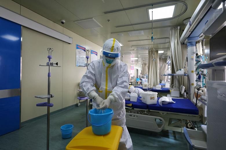 A hospital ward being cleaned in Wuhan on Thursday. With the outbreak in China appearing to be getting under control as the US struggles with its response, Beijing is pushing the narrative that it has claimed victory over the virus.