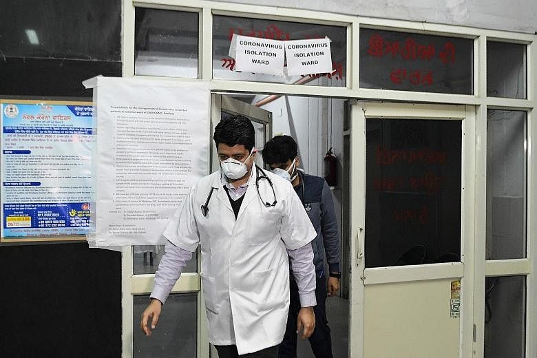 Doctors in front of an isolation ward for coronavirus patients at Guru Nanak Dev Hospital in Amritsar, India, on March 7. India has set up 52 testing stations and is creating more such facilities.