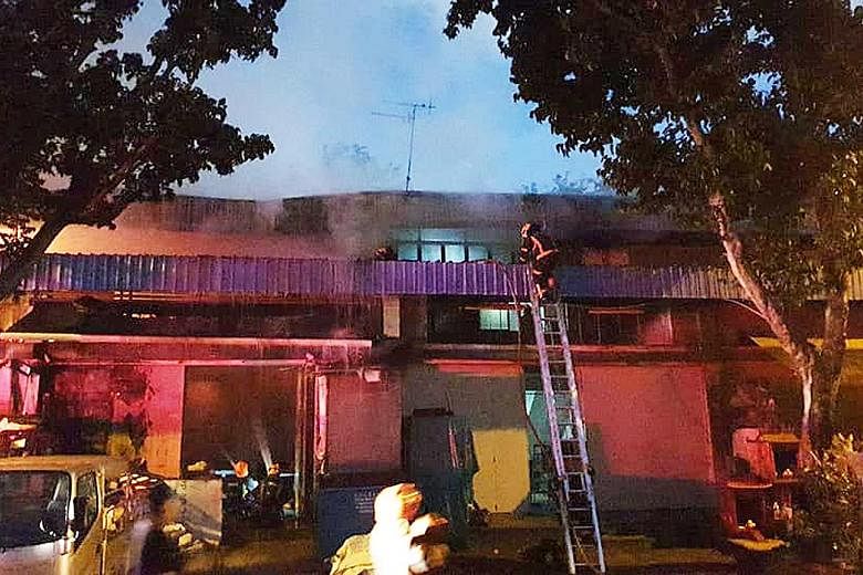 The Singapore Civil Defence Force used four handheld jets and an aerial water monitor to bring the fire at a warehouse in Eunos under control early yesterday. PHOTO: SINGAPORE CIVIL DEFENCE FORCE