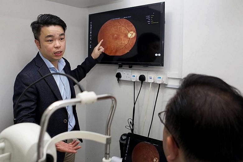 Singapore Optometric Association president Ken Tong analysing the image of a patient's retina on AI system Selena+. The system can tell from the photo of a person's eye whether he has diabetic retinopathy, glaucoma or age-related macular degeneration