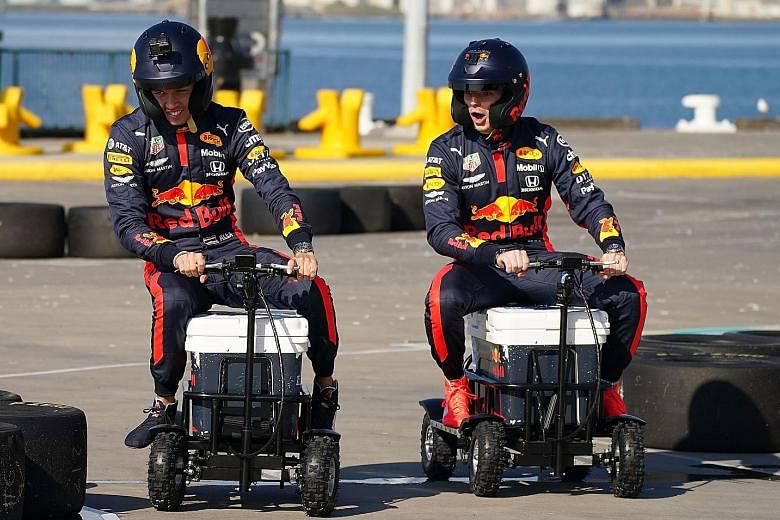 Red Bull driver Max Verstappen (right) and teammate Alexander Albon riding on a motorised cooler at a sponsor's event in Melbourne before the Australian Grand Prix was cancelled. 