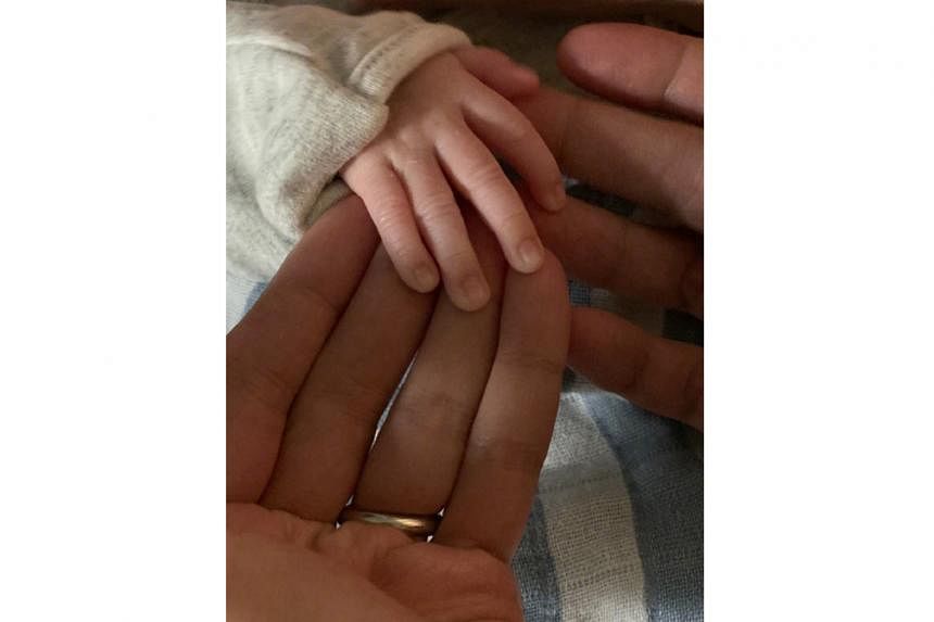 Leo Ku posted photos of his newborn, including one where his, his wife's and the baby's hands are touching (above).