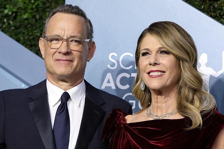 Actor Tom Hanks and his wife Rita Wilson, seen here in January, tested positive for the coronavirus last week and are now self-quarantined, their son said.