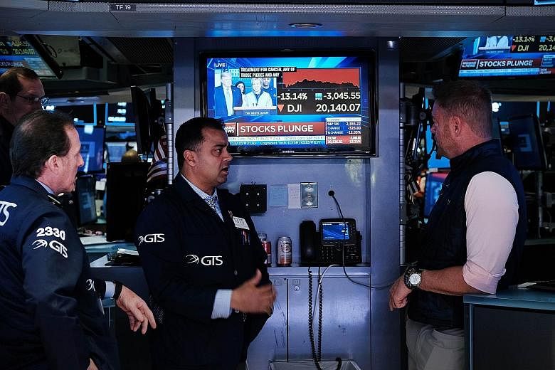 Traders on the floor of the New York Stock Exchange. The level of debt in the US corporate sector is 75 per cent of the country's gross domestic product, breaking the previous record set in 2008. PHOTO: AGENCE FRANCE-PRESSE
