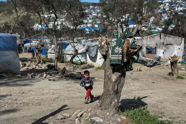 A child in the refugee camp of Moria on the Greek island of Lesbos on Monday. The EU has urged Turkey to stop migrants in the country - from Afghanistan, Pakistan, Syria and countries in Africa - from trying to cross the border to Greece and on to th