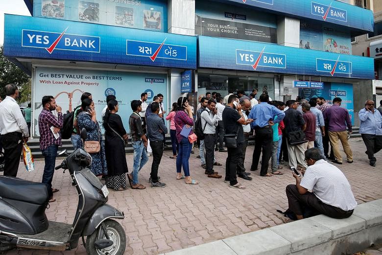 Yes Bank founder Rana Kapoor arriving at the Enforcement Directorate office in Mumbai earlier this month. PHOTO: REUTERS People waiting outside a Yes Bank branch to withdraw their money in Ahmedabad, India. Earlier this month, India's central bank im
