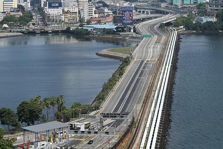 The Causeway between Johor and Singapore devoid of any vehicles at 10am yesterday, after Malaysia's movement control order took effect. However, movement of essential supplies across the border continued, with Trade and Industry Minister Chan Chun Si