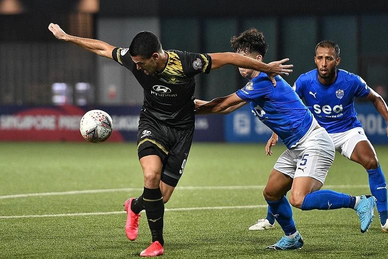 Tampines Rovers' Boris Kopitovic shielding the ball against Lion City Sailors players. He got the breakthrough on the hour mark to spark the 4-0 rout at Our Tampines Hub. ST PHOTO: ARIFFIN JAMAR