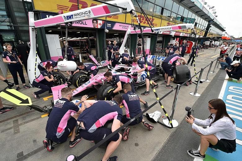 The Racing Point F1 team rehearsing their pit stops last Friday before the first practice session of the season-opening Australian race in Melbourne. That was called off just hours before the action was due to start and no racing is likely before end