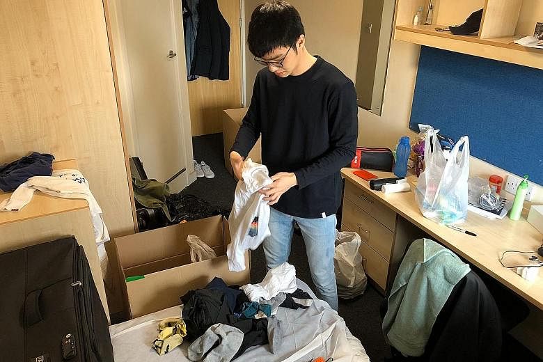 University of Manchester student Joel Chan, 22, packing up as he prepares to fly back to Singapore today. He is among the thousands of students heading home after the Ministry of Foreign Affairs urged Singapore students abroad to consider doing so am