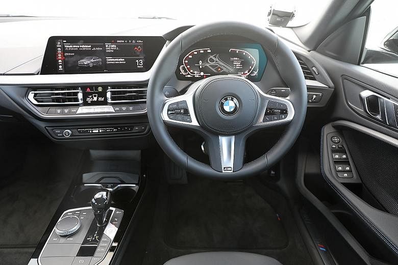 The BMW 218i Gran Coupe has premium switchgear in the cockpit (above), responsive climate control as well as 430 litres of stowage in the boot.