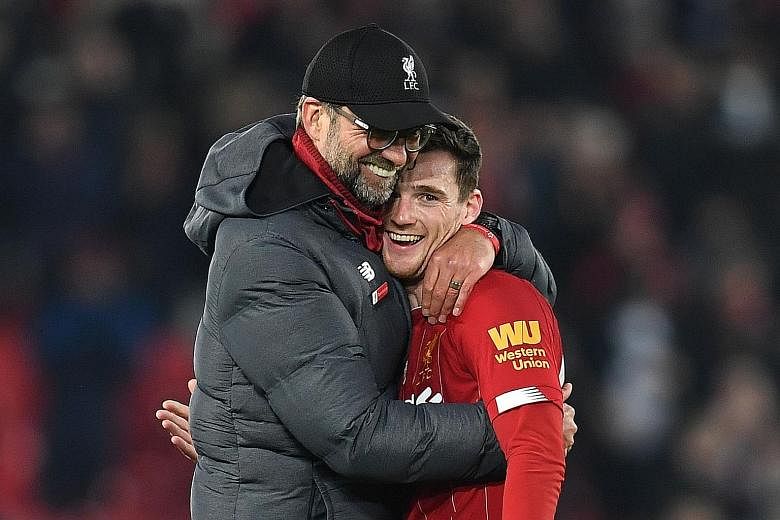 Liverpool manager Jurgen Klopp embraces Reds defender Andrew Robertson after a game against Wolverhampton Wanderers last December. The German's hands-on approach and empathy have won him many fans in the locker room. 