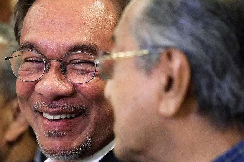 Malaysian politician Anwar Ibrahim and then Prime Minister Mahathir Mohamad in happier times, last November.