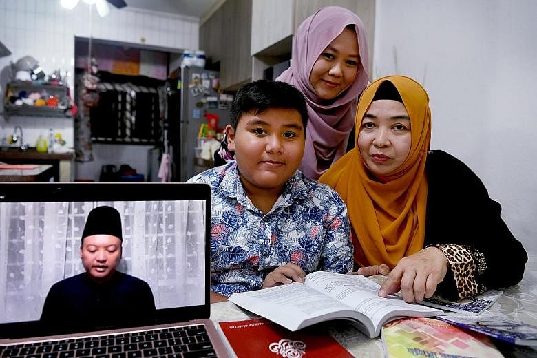 Ms Siti Aishah Mohd Kassim, her mother Rahmah Haji Karim and her nephew Muhammad Timidzi Zulkeffle watch lectures by local Muslim religious leaders online as mosques are closed until Thursday.