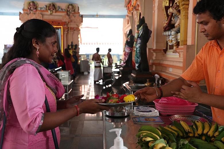 Prasadham, food and flowers that have been blessed, are given to devotees on platters, instead of by hand, to avoid unnecessary contact at Sri Darma Muneeswaran Temple.