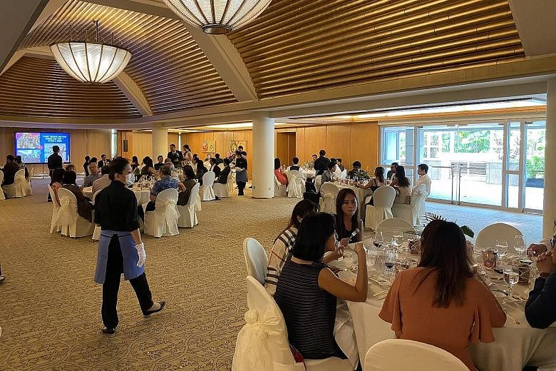 Guests at a wedding yesterday at the Ritz-Carlton, Millenia Singapore sitting at tables that were placed at least a metre apart. A restaurant (right) implementing social distancing measures at Jurong Point, with patrons sitting at alternate tables, y