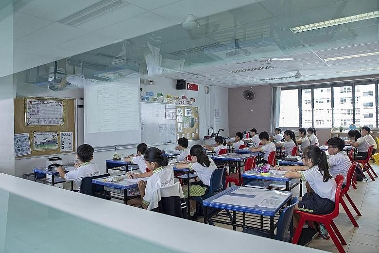 New seating arrangements to maintain safe distancing at Punggol Green Primary School. Students who have to miss classes will be put on home-based learning. Staff at the entrance of Zhenghua Primary School in Fajar Road yesterday morning asking pupils