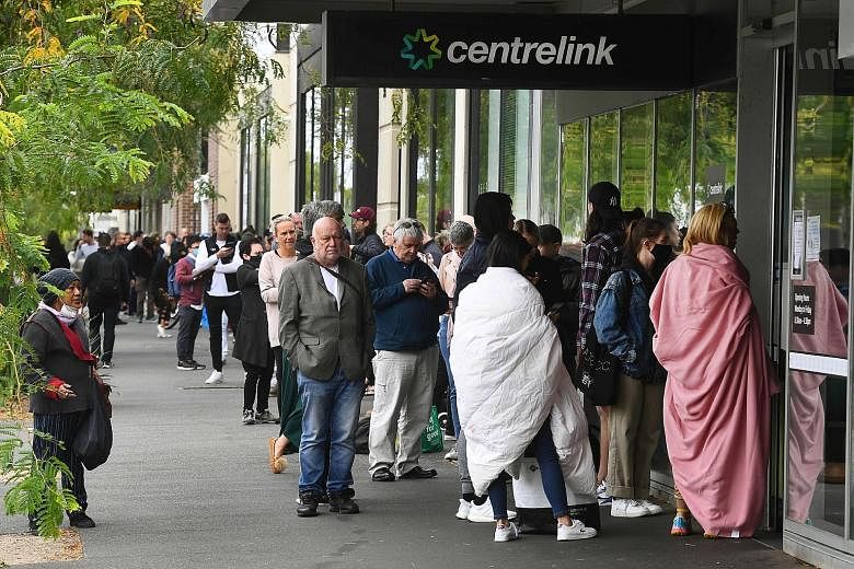 A long line of people waiting to enter an Australian government social welfare office, Centrelink, in Melbourne yesterday. Jobless Australians flooded unemployment offices around the country as the forced closure of pubs, casinos, churches and gyms b