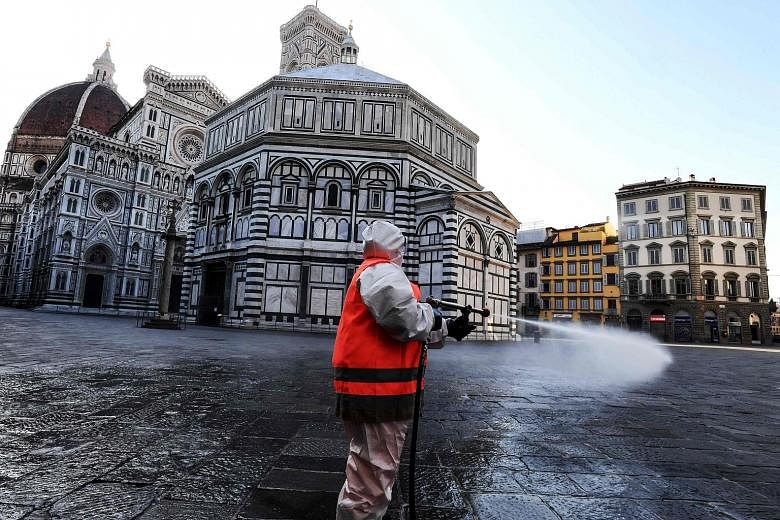 A municipal company employee disinfecting Piazza del Duomo in Florence last Saturday as part of the measures taken by the Italian government to fight against the spread of Covid-19.