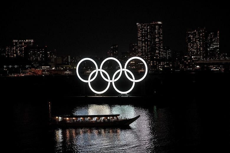 The Olympic rings flicker in Tokyo's Odaiba Marine Park, while clamour to extinguish hopes that Japan will hold the Games as scheduled in July grow ever louder.