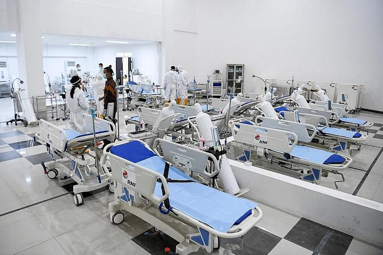 Medical staff preparing a room for patients yesterday at the 2018 Asian Games athletes' village in Jakarta which has been converted into a hospital for Covid-19 cases.
