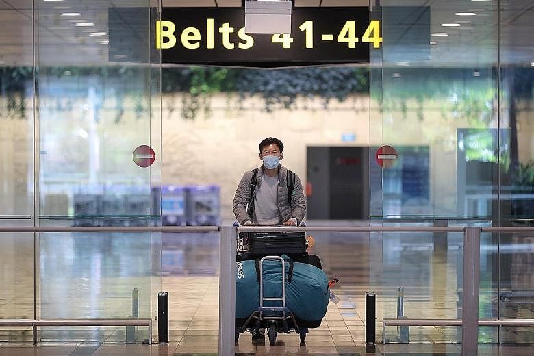 A passenger arriving at Changi Airport Terminal 3 yesterday. Out of Singapore's 141 cases of Covid-19 patients aged between 20 and 29 years old, 78 per cent, or 111 cases, were imported. ST PHOTO: GAVIN FOO