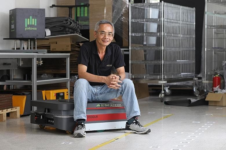 Mr Joseph Yap, a technical project manager at Kaze Robotics, with an automated guided vehicle which he has been working on.