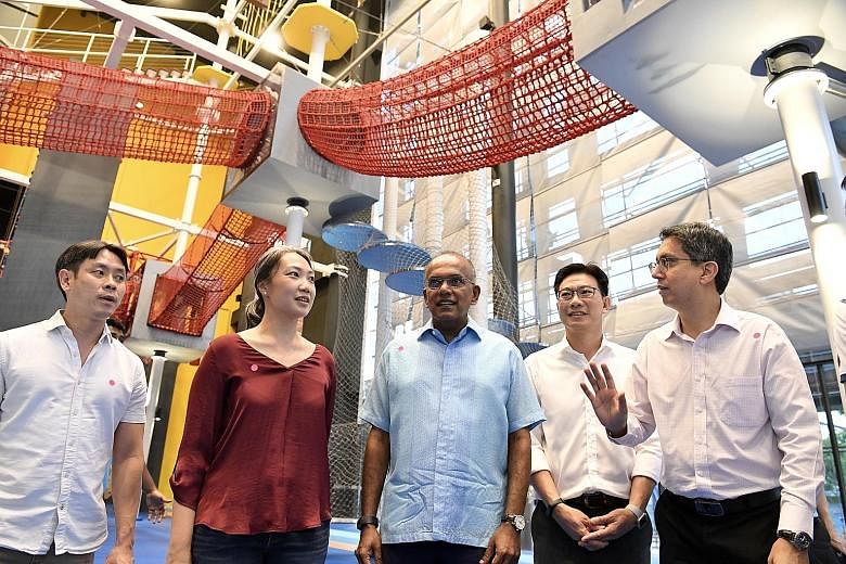 Charity founder Carrie Tan and DBS Bank managing director and head of group audit Derrick Goh (fourth from left) with Home Affairs and Law Minister K. Shanmugam and his fellow Nee Soon GRC MPs Louis Ng (far left) and Muhammad Faishal Ibrahim at the n