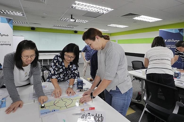 A coding class at the NTUC LearningHub in Bras Basah. Singaporeans can check which courses are eligible for the early use of their SkillsFuture Credit top-up on the MySkillsFuture portal. ST PHOTO: GAVIN FOO