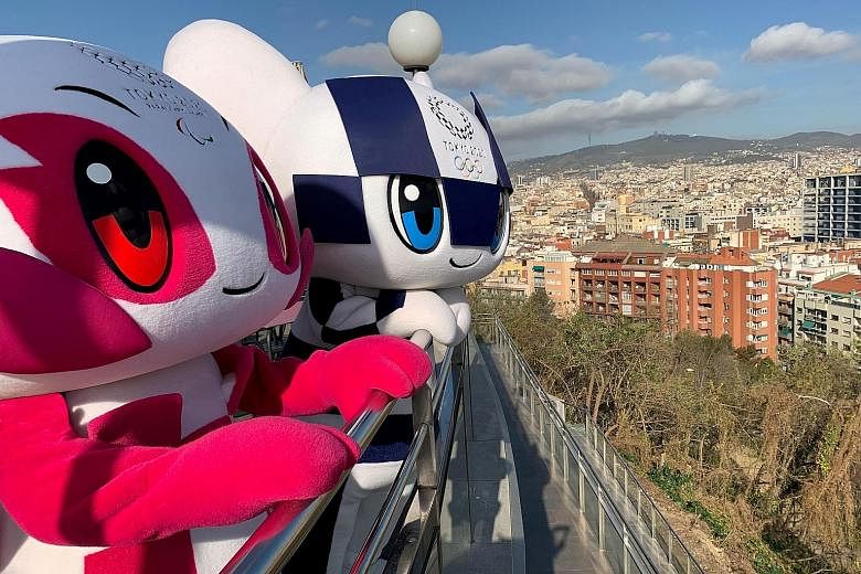 Tokyo 2020 mascots Someity (Paralympics) and Miraitowa (Olympics) on their Make The Beat tour in Barcelona this month. The Games were deferred on Tuesday. PHOTO: REUTERS