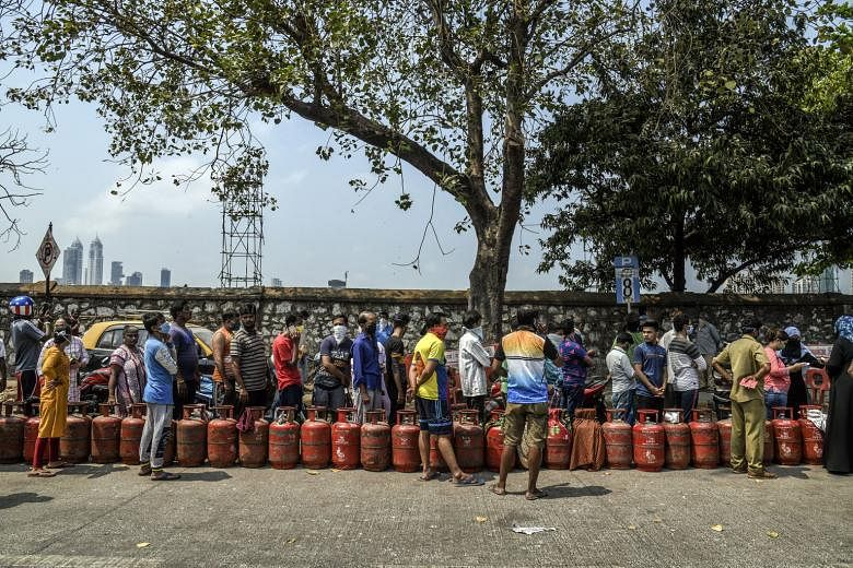 People waiting to purchase cooking gas in Mumbai on Wednesday. India went into lockdown from midnight on Tuesday to prevent the further spread of Covid-19. The complete cessation of economic activity is hitting the poor the hardest.