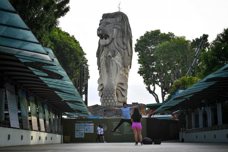 Visitors at Sentosa last month. Commercial properties more severely affected by the Covid-19 outbreak, including hotels, tourist attractions, shops and eateries, will not have to pay any property tax this year. ST PHOTO: CHONG JUN LIANG