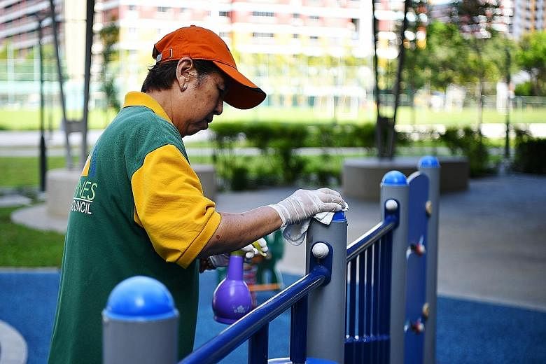 Cleaner Ling Li, 70, cleaning a playground in Tampines last month. Disinfectants and alcohol-based sanitiser break the lipid membrane encasing a coronavirus' genetic material, rendering the virus impotent and incapable of infecting its host.