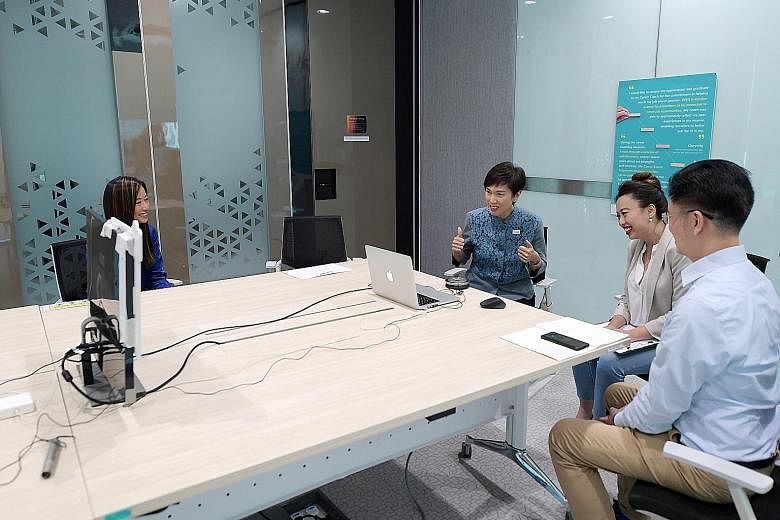 Manpower Minister Josephine Teo and School of Concepts director Mint Lim (second from right) interacting with jobseekers in a virtual networking session at Workforce Singapore's office yesterday, with Mr Chris Lau, senior career coach at WSG's career