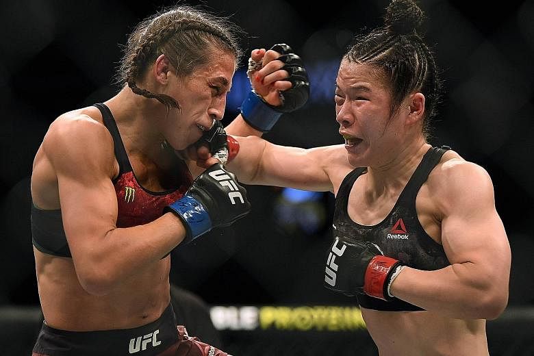 Zhang Weili punching Joanna Jedrzejczyk on her way to a split-decision win earlier this month in Las Vegas, Nevada. 