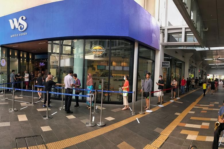 A long queue outside White Sands in Pasir Ris yesterday, as the mall regulated the flow of shoppers entering. 