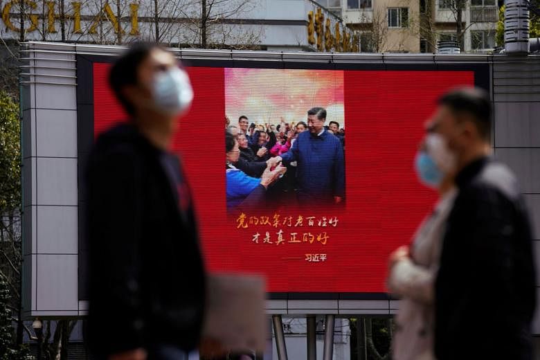 A big screen in Shanghai displaying an image of Chinese President Xi Jinping on Monday, after the Chinese city's emergency alert level was downgraded as the coronavirus situation improved. The number of infections in the United States has surged past