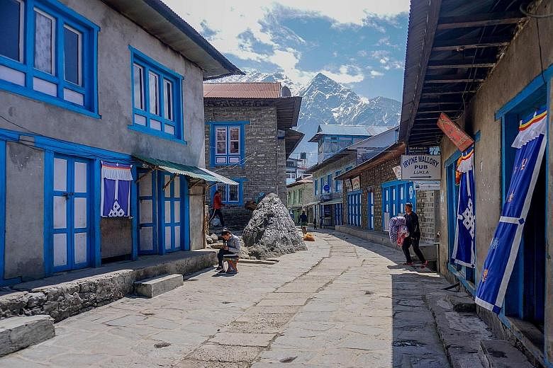 Closed shops and restaurants along an almost deserted street in Lukla, the main gateway to the Everest region in Nepal, during a government-imposed nationwide lockdown as a preventive measure against the coronavirus yesterday. Foreign governments on 