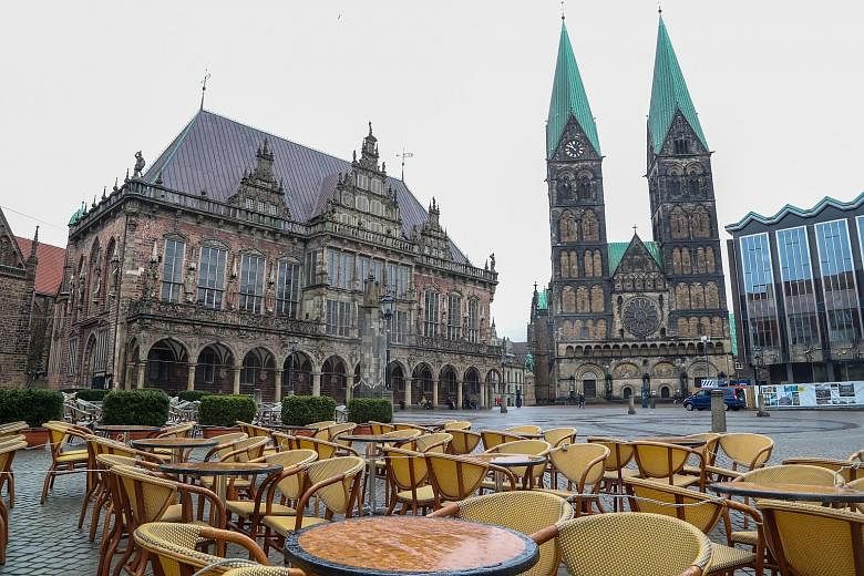 An empty cafe in a nearly deserted square in Bremen, Germany, on March 19. The effects of the coronavirus pandemic mean that hundreds of thousands of small businesses that were flourishing only two weeks ago are now suffering the anguish of having no